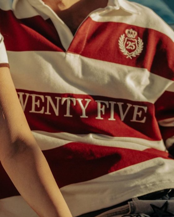 Detail of the red and white Twenty Five rugby shirt with its crest